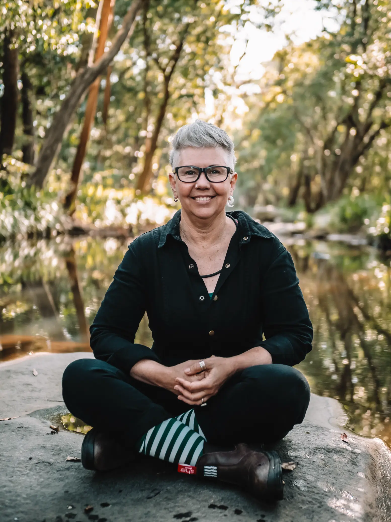 From the Ground up Counselling - Jaq (counsellor) reflecting by the water's edge in a peaceful natural setting